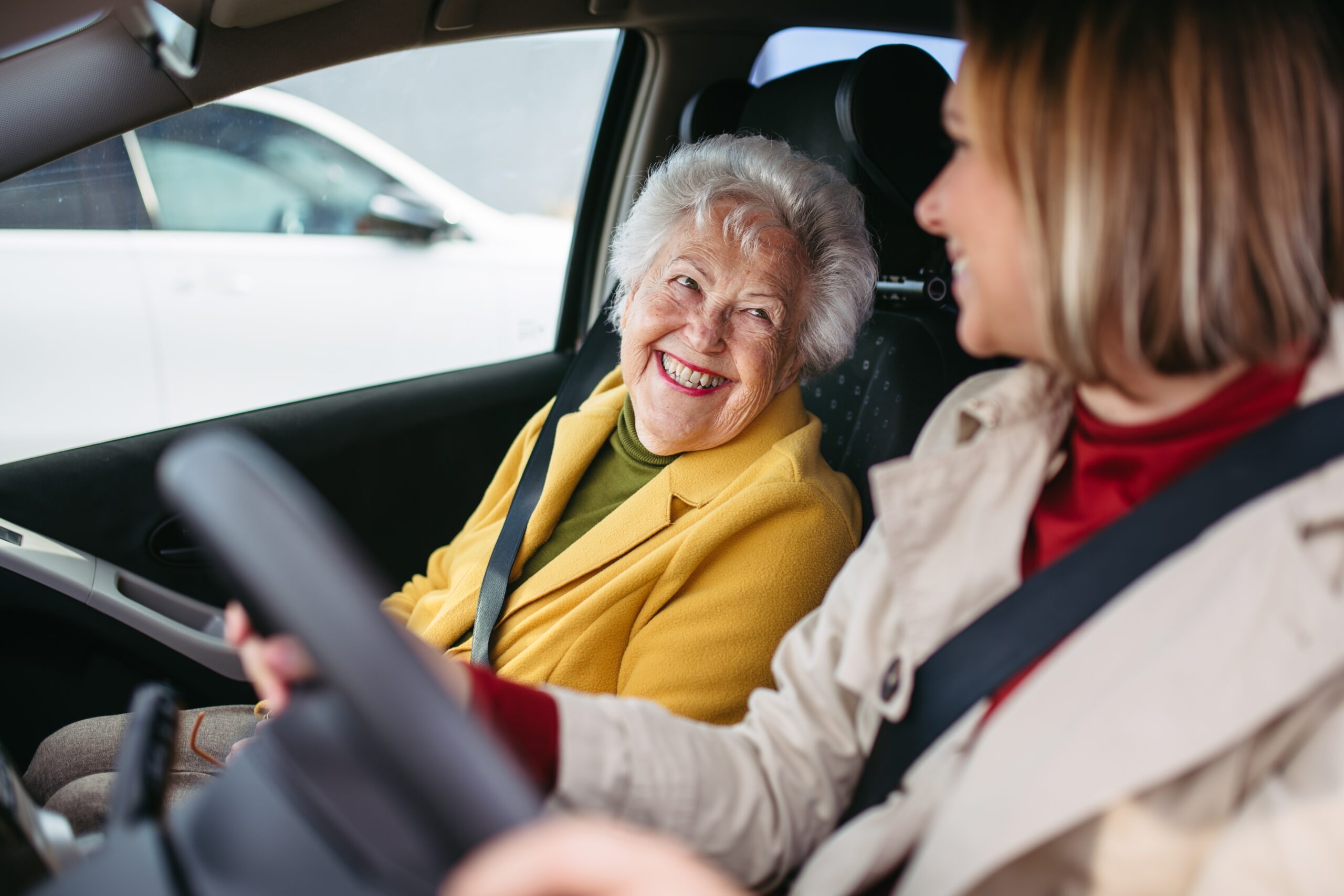 Granddaughter Driving Her Elderly Grandmother In The Car