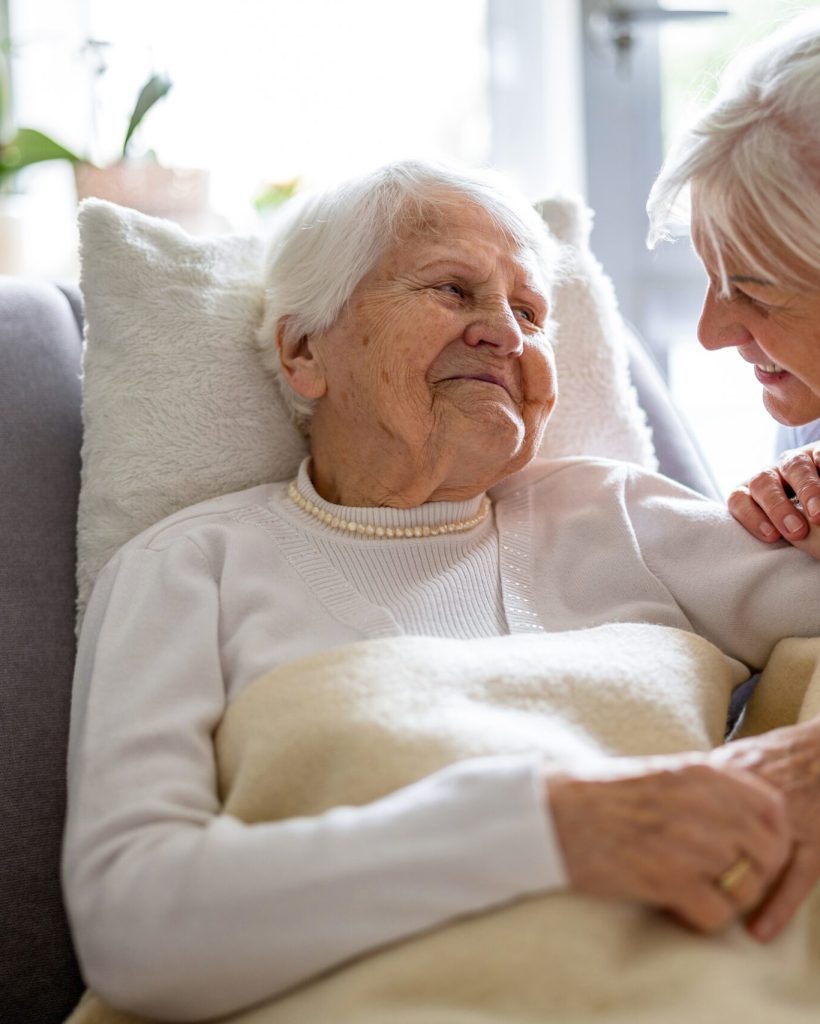 Elderly Woman With Her Caregiver At Nursing Home