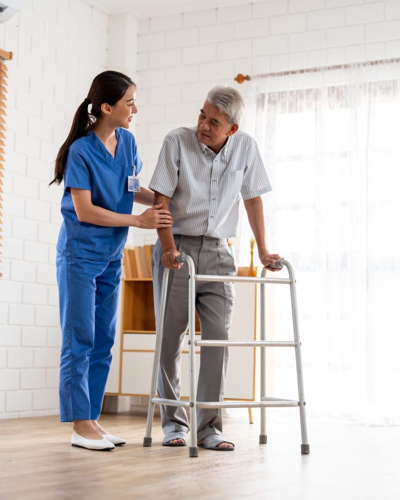 Asian Senior Elderly Man Patient Doing Physical Therapy With Caregiver.